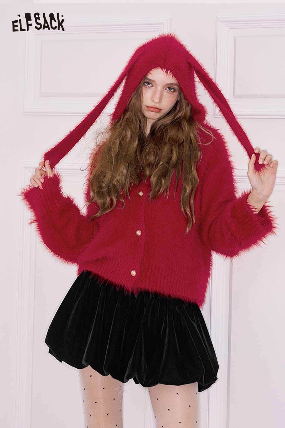 ELFSACK bunny ear hood cropped cardigan in bright pink, paired with a black velvet skirt