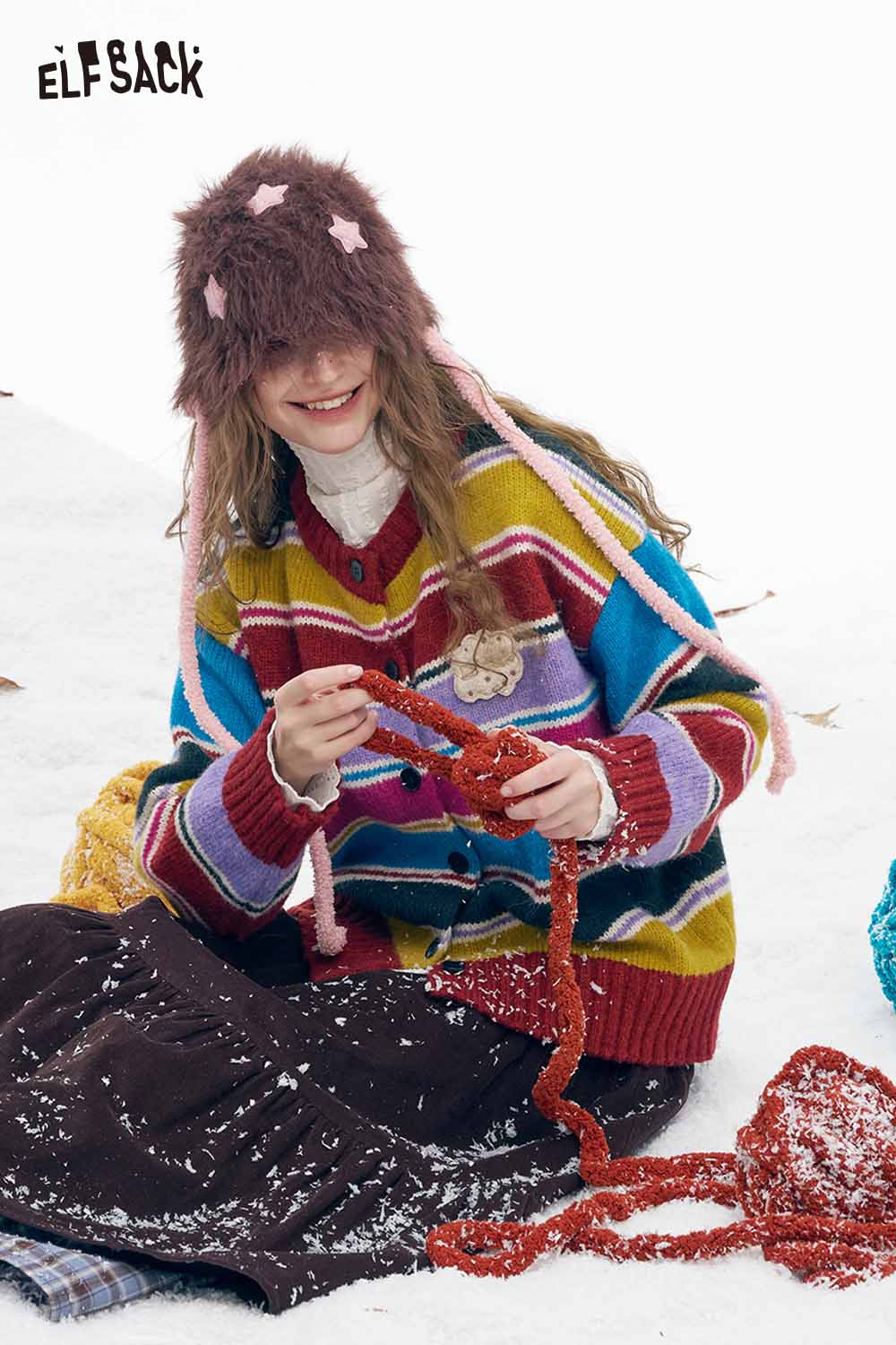 ELFSACK stripe embroidery button sweater in colorful stripes worn by a smiling girl outdoors in winter