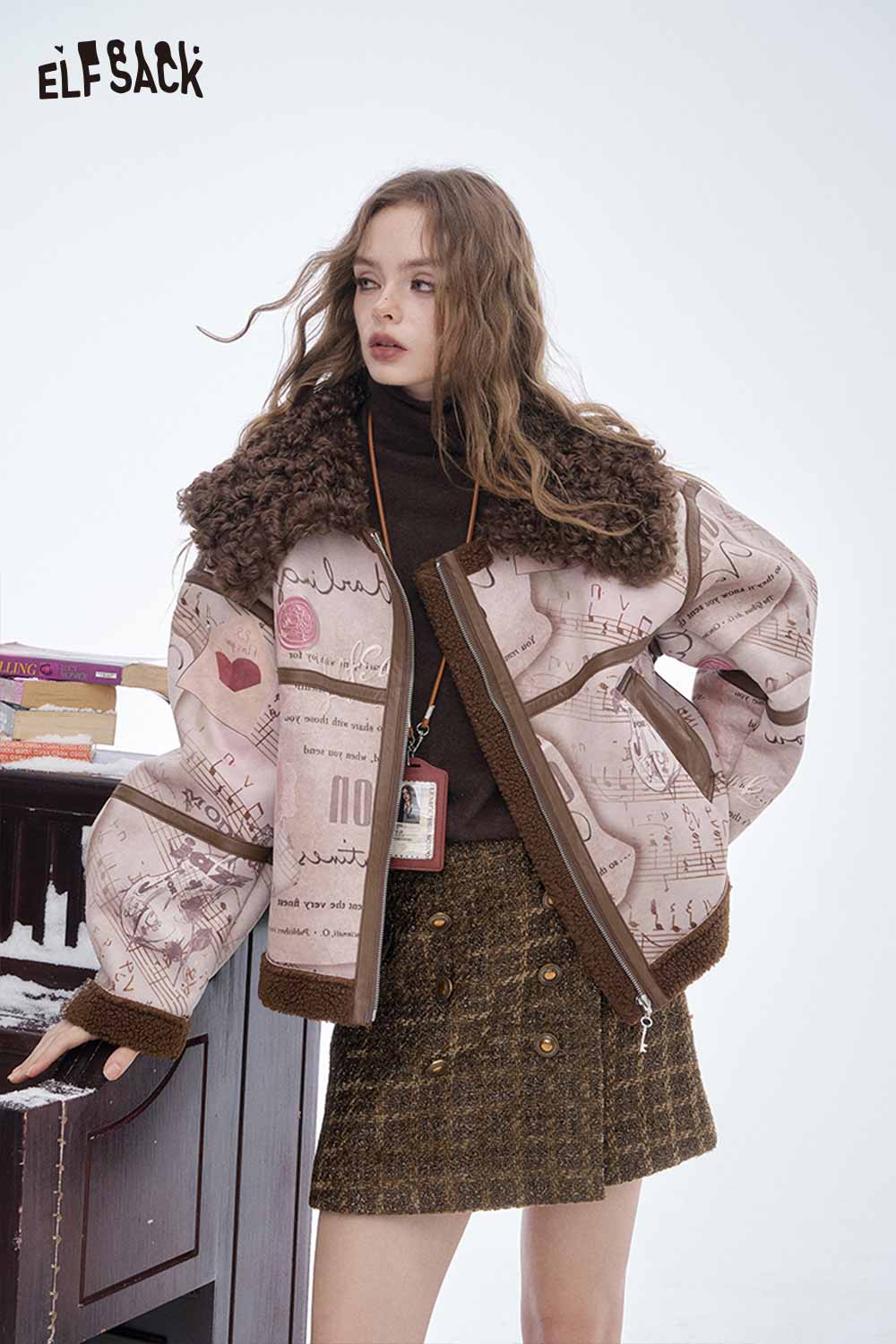 Model wearing a striped gold button A-line skirt paired with a stylish oversized jacket