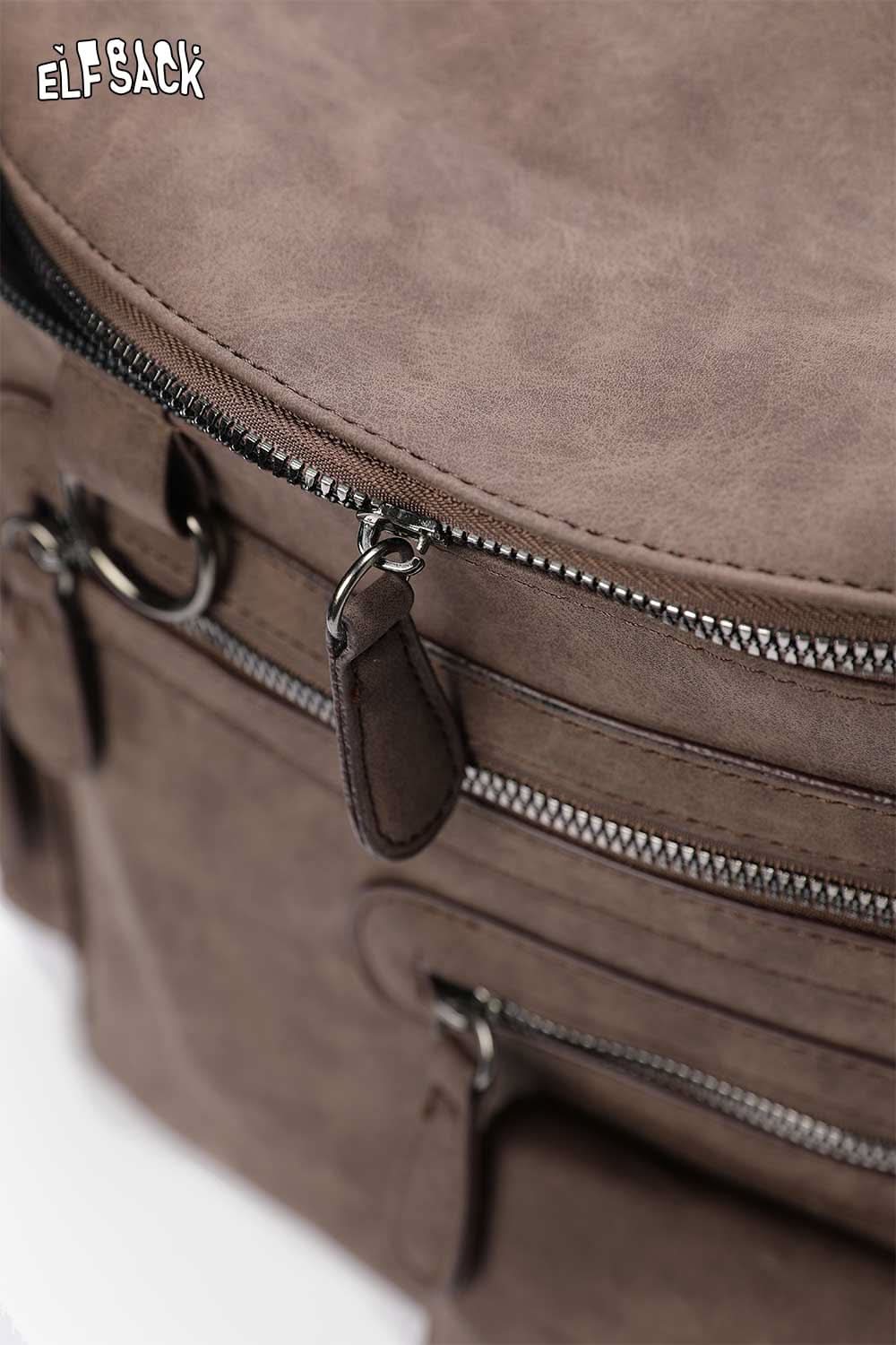 ELFSACK suede multi-compartment rucksack featuring multiple zippered pockets for organized storage