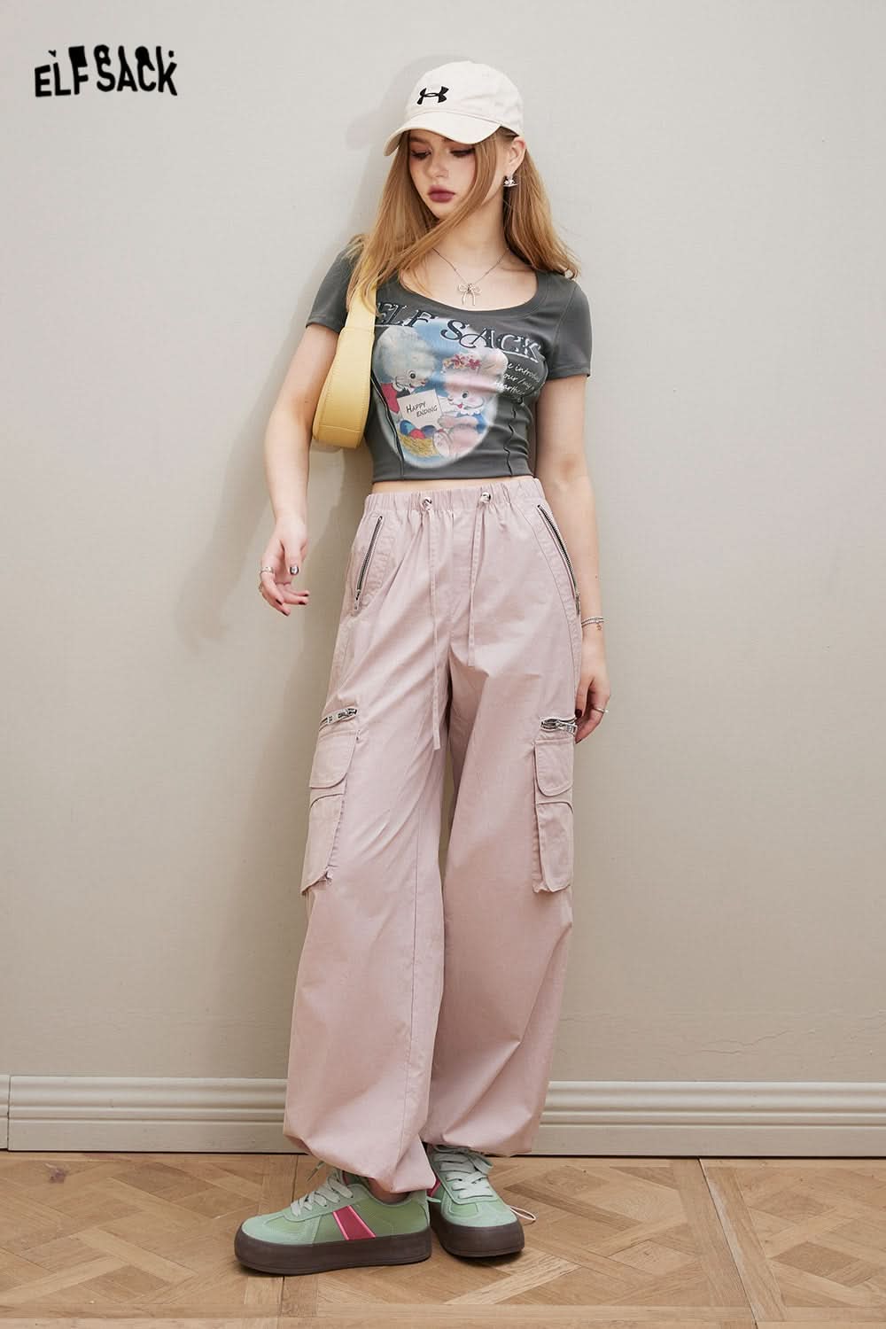 ELFSACK Sweet & Spicy graphic print fitted T-shirt worn by model with light pink cargo pants and white cap