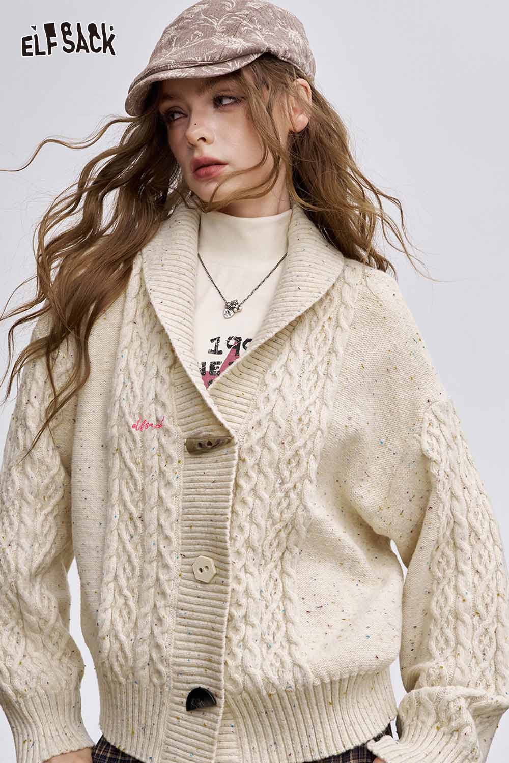 ELFSACK irregular button knit sweater in cream with textured cable knit design and oversized fit
