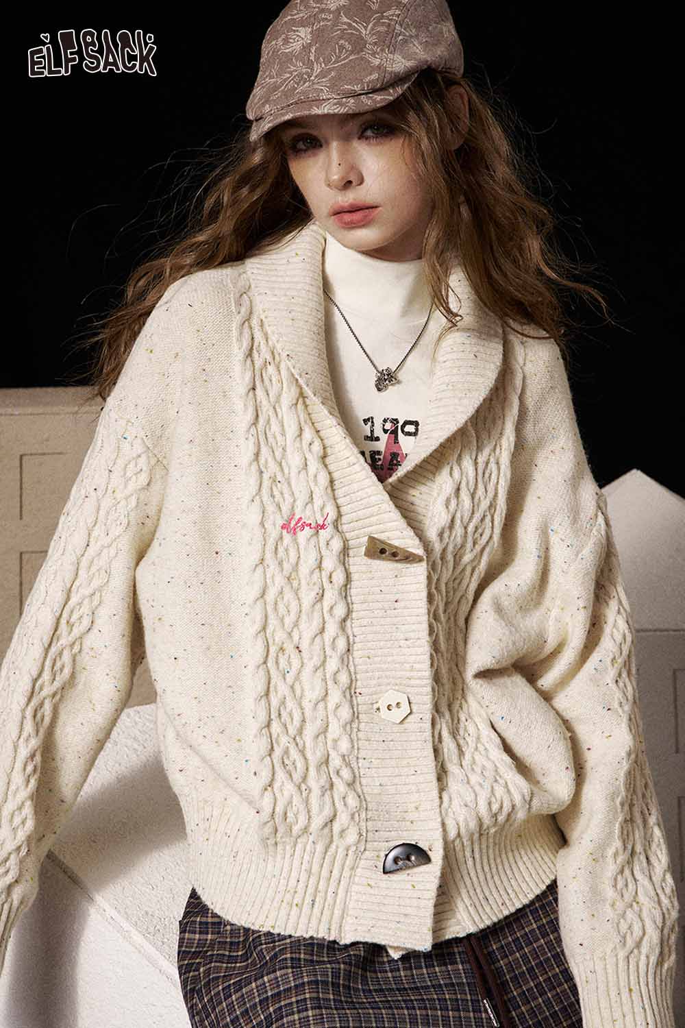 ELFSACK irregular button knit sweater in cream featuring a cozy oversized design with cable knit pattern