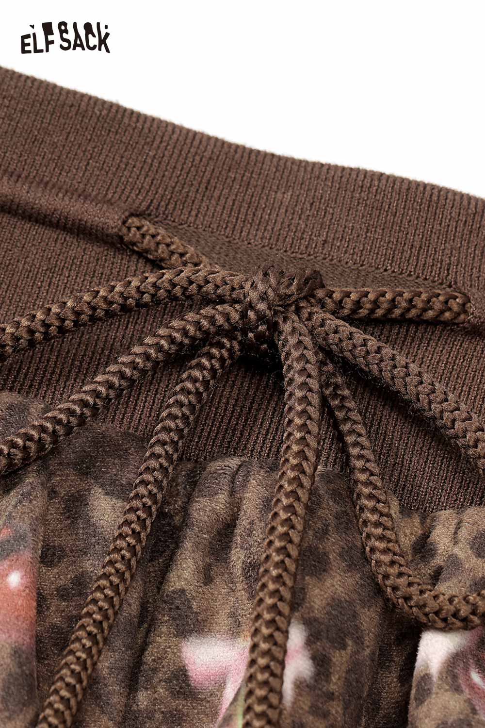 Close-up of ELFSACK leopard print pleated skirt showcasing waistband detail and drawstring feature