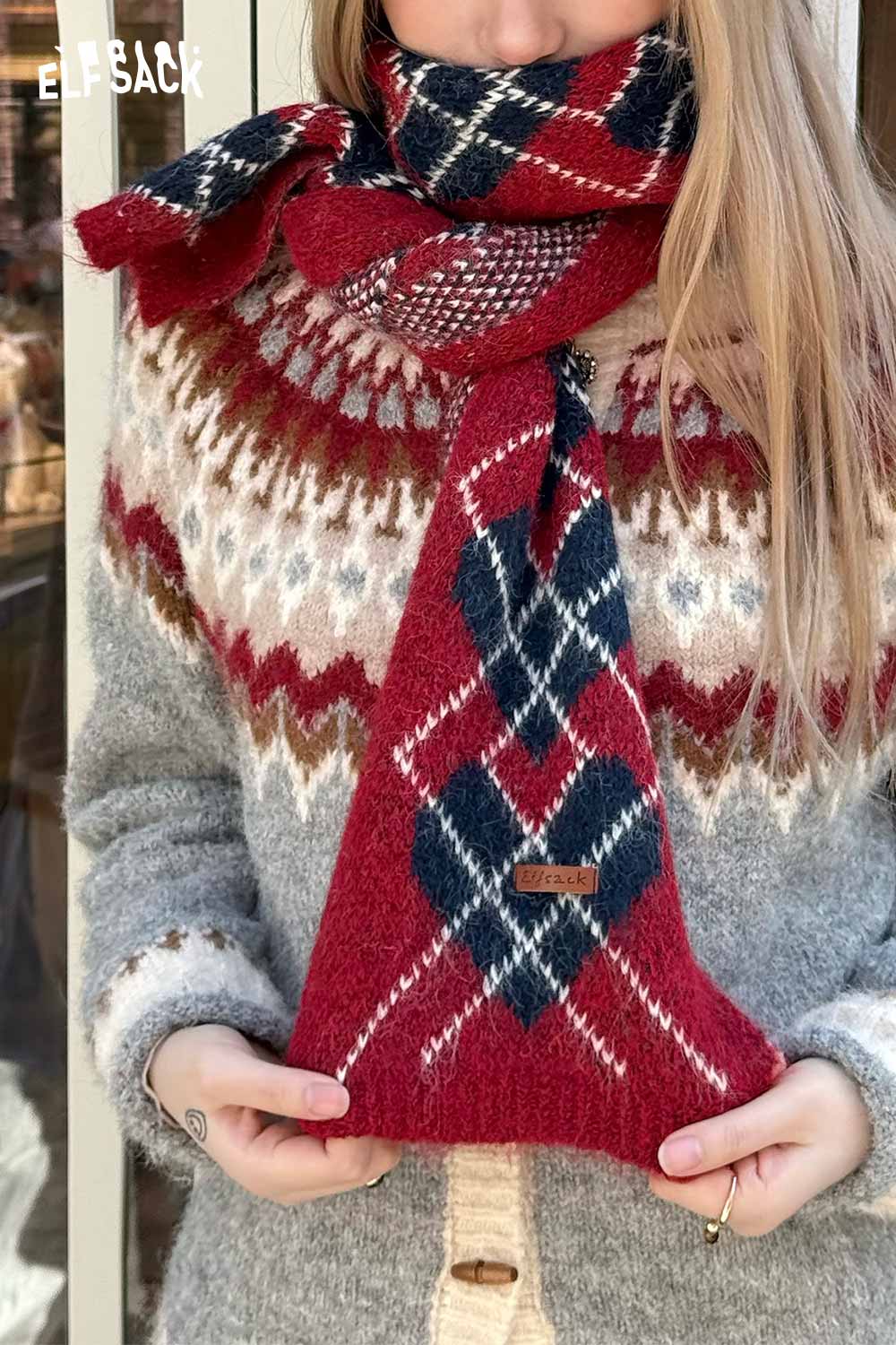 ELFSACK minimalist diamond pattern scarf in red and blue, styled with a cozy sweater