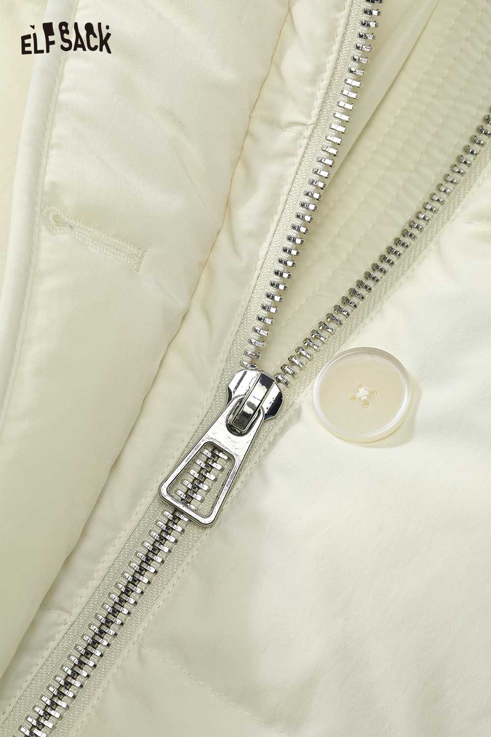 Close-up of ELFSACK minimalist long down coat for women featuring a silver zipper and button detail