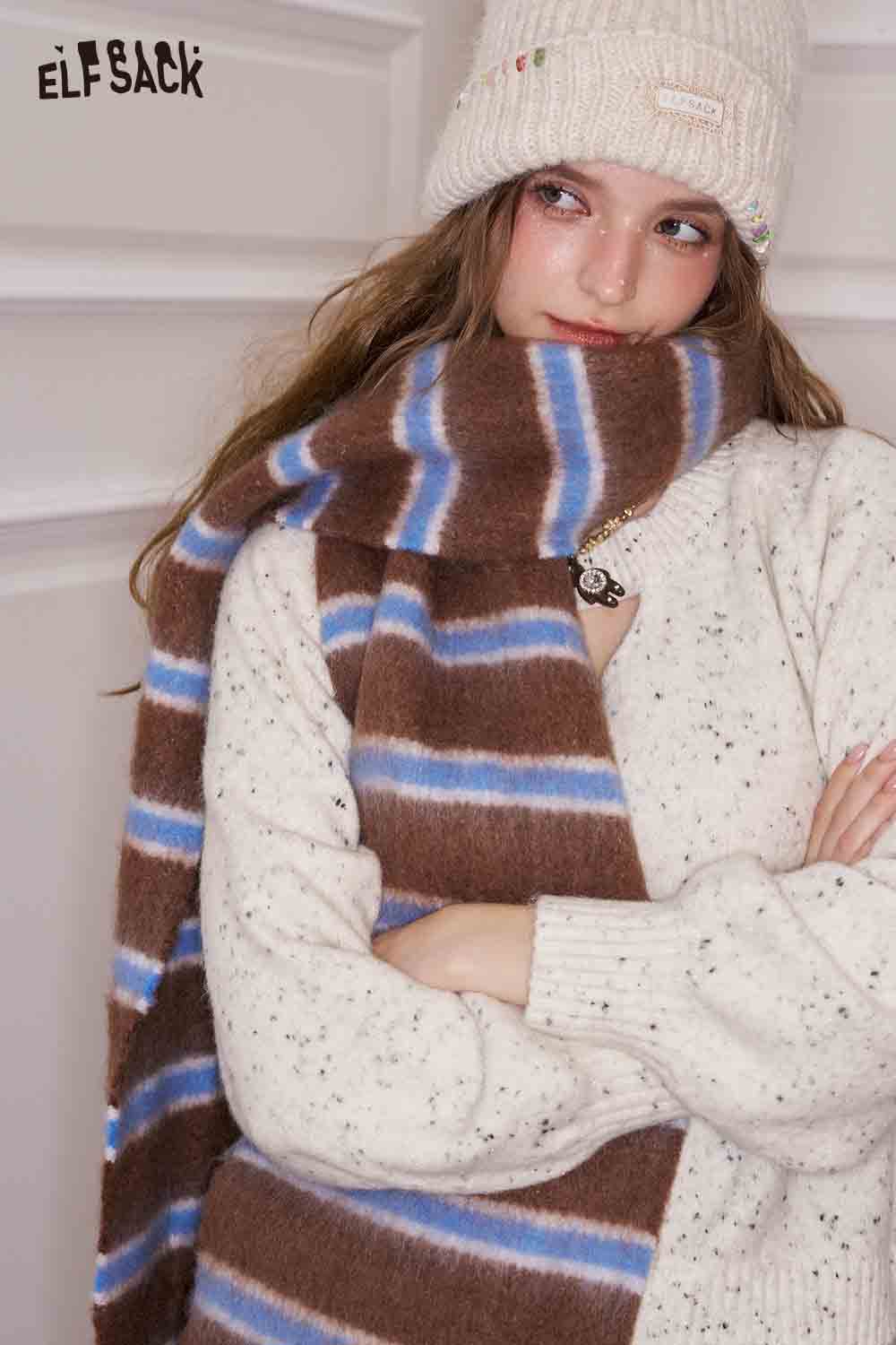 ELFSACK preppy striped fringe scarf in soft brown and blue tones, styled with a cozy outfit