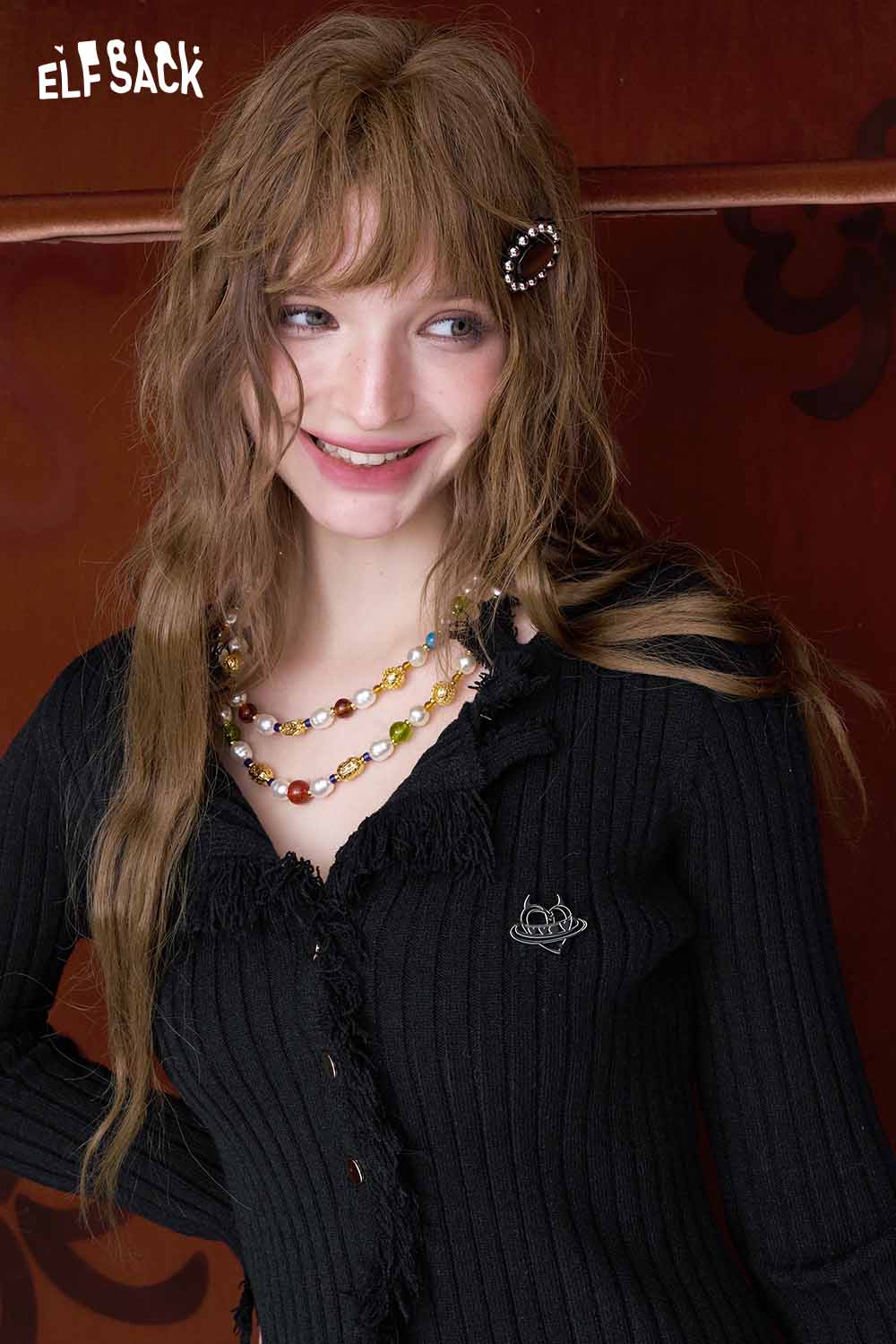 Stylish black ELFSACK slim fit heart logo knit sweater with frayed edges and decorative buttons