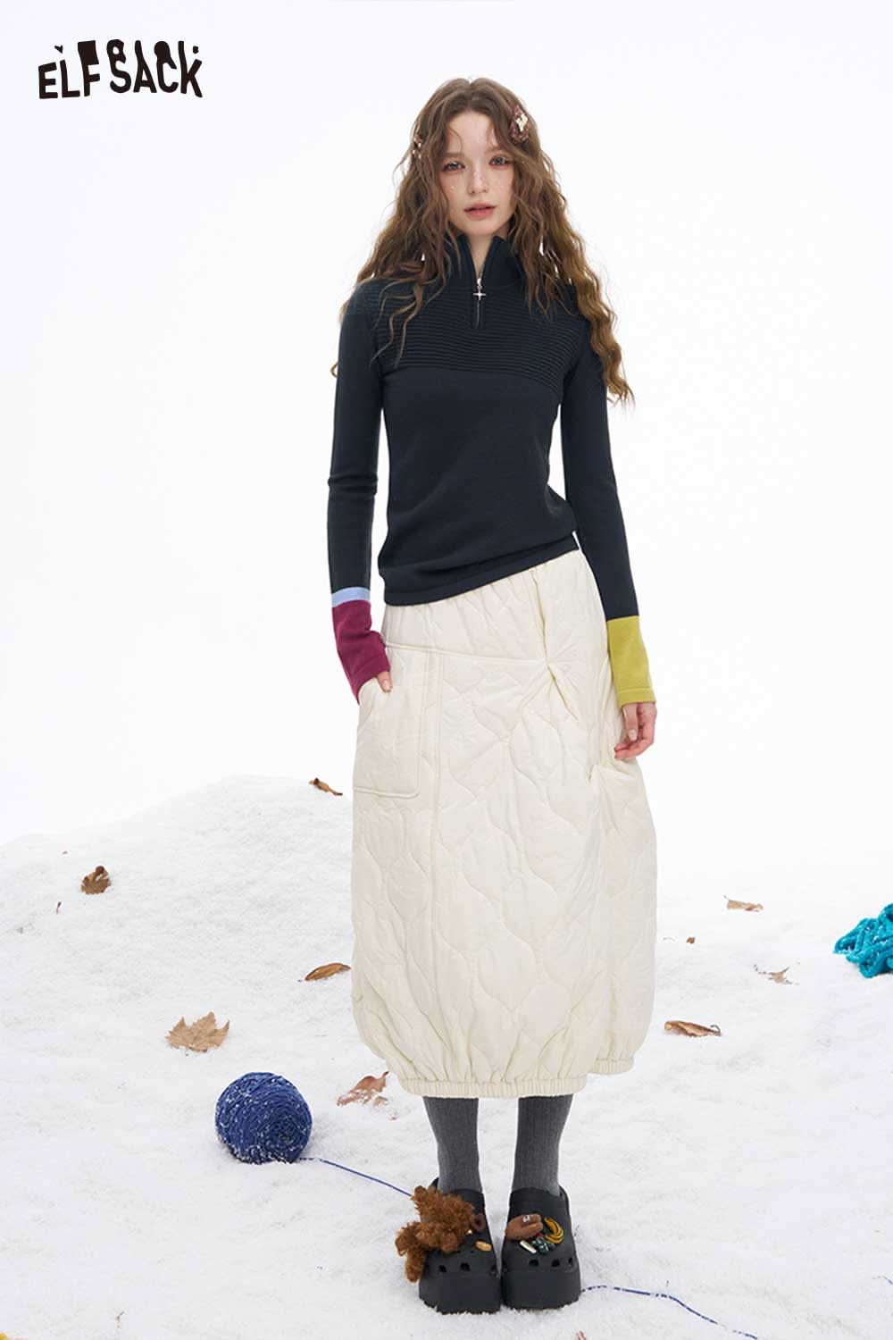 ELFSACK soft contrast sleeve knitwear featuring a zip neck and colorful sleeves for a stylish look