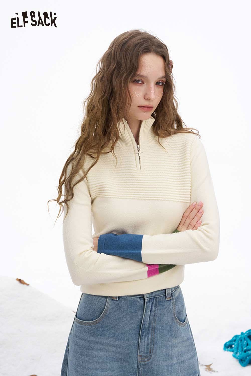 ELFSACK soft contrast sleeve knitwear featuring a half-zip design with colorful sleeves and a comfortable fit.