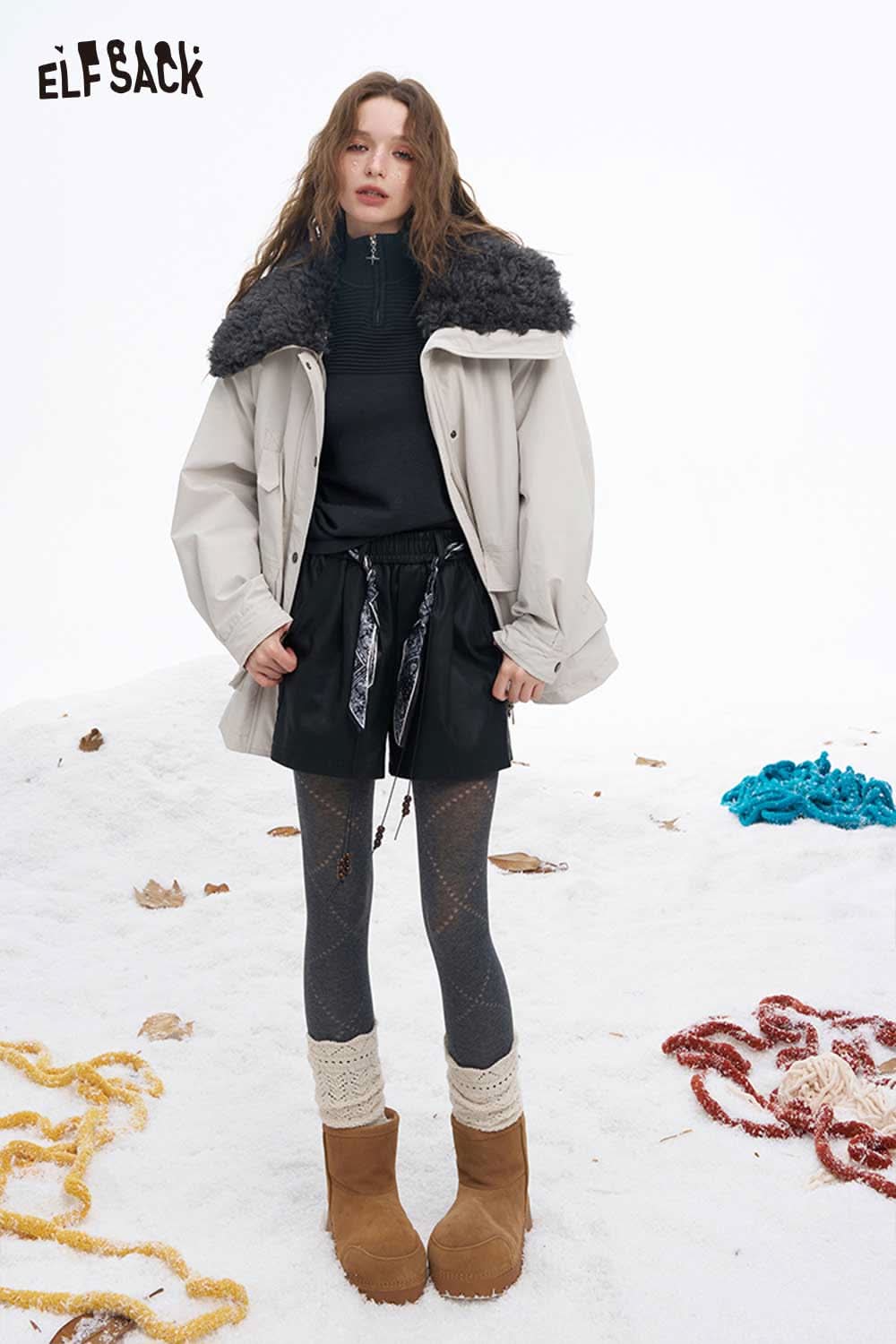 ELFSACK soft contrast sleeve knitwear paired with a stylish jacket and winter boots in a snowy setting