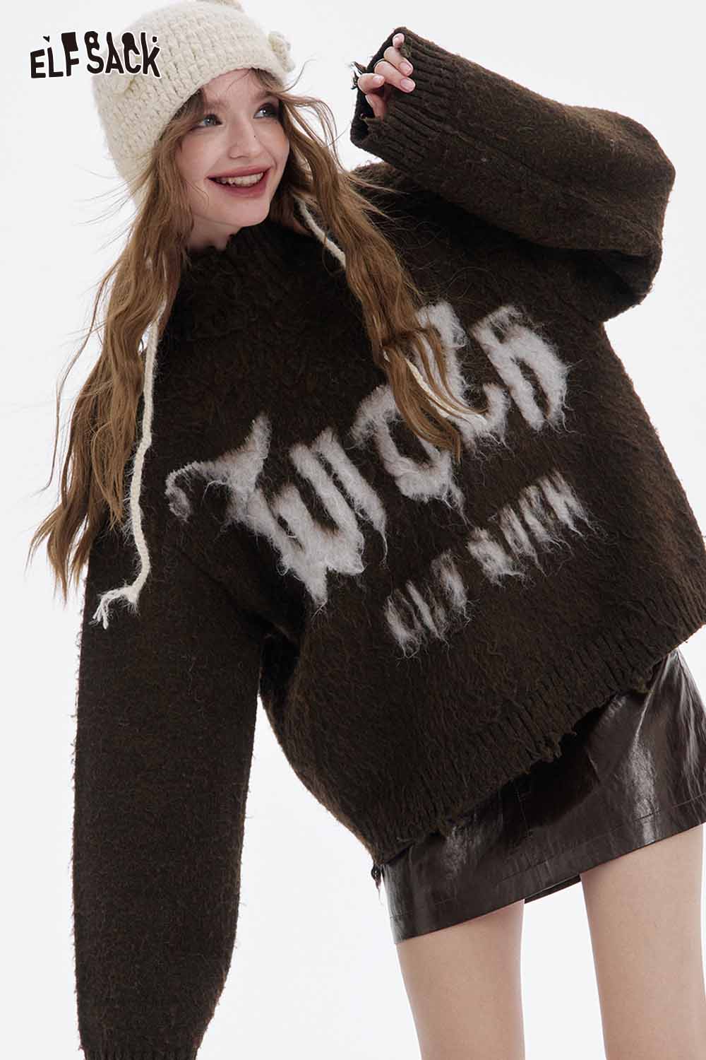 Model wearing a soft shiny leather skirt with an oversized sweater and a knitted hat from ELFSACK