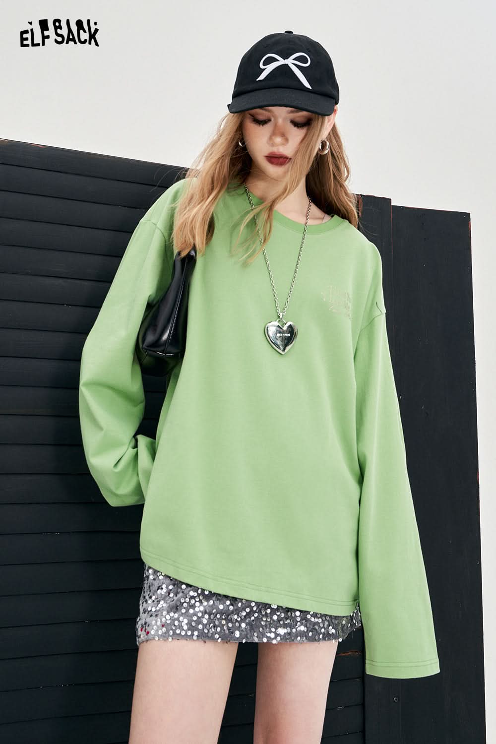 ELFSACK green long sleeve Y2K Alphabet Graphic T-shirt worn with sequin skirt and black cap