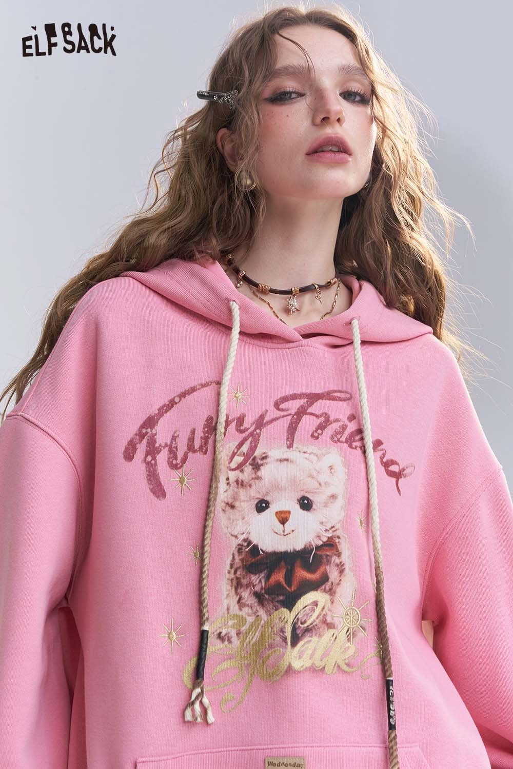 ELFSACK vintage cartoon graphic hoodie in pink featuring a cute bear design and glitter accents