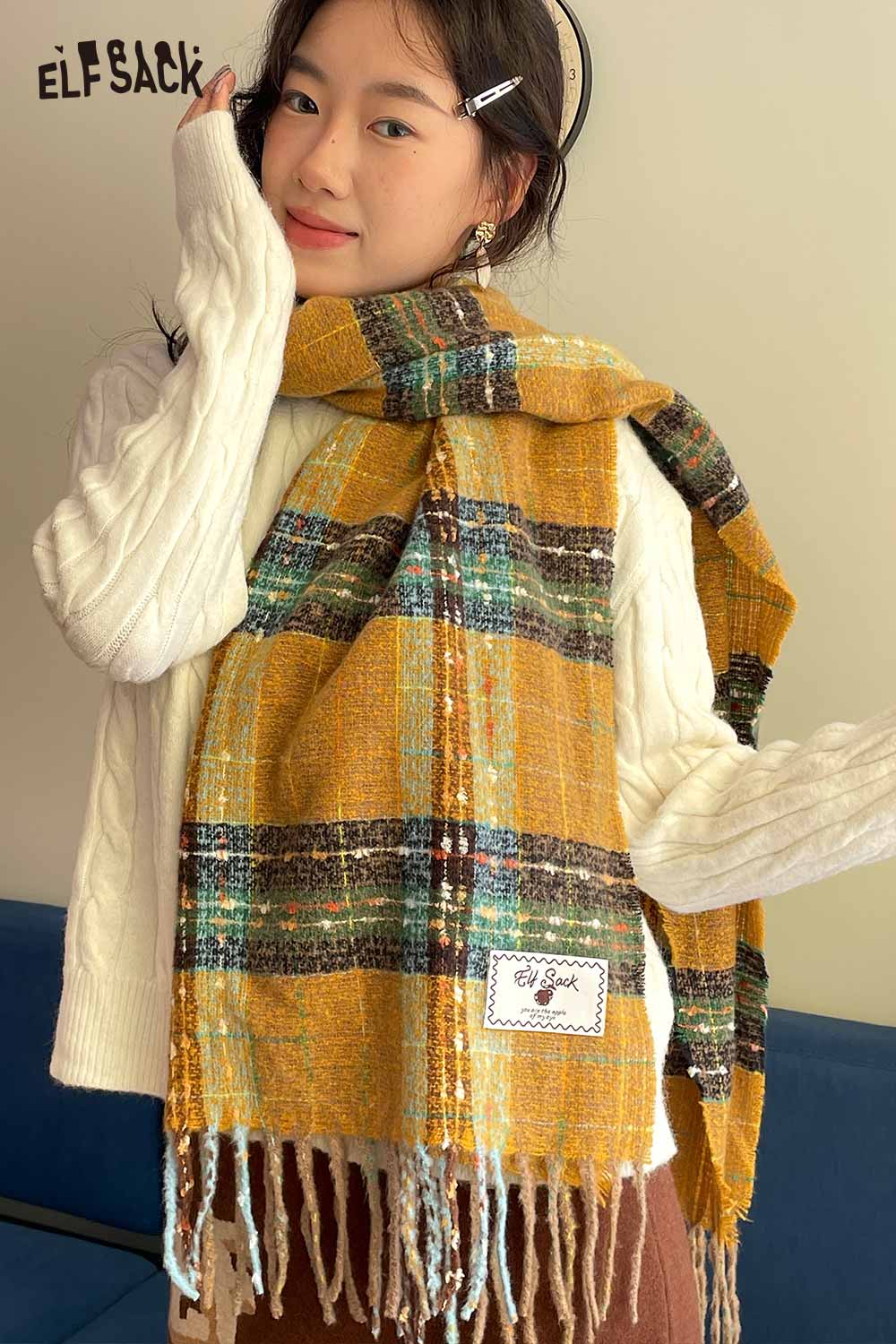 Woman wearing a vintage plaid wool scarf styled with a cozy white sweater for a chic look
