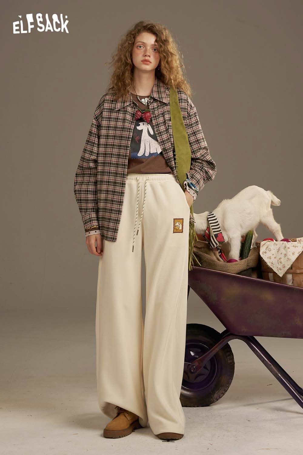 ELFSACK vintage print long sleeve t shirt styled with a plaid shirt and light pants