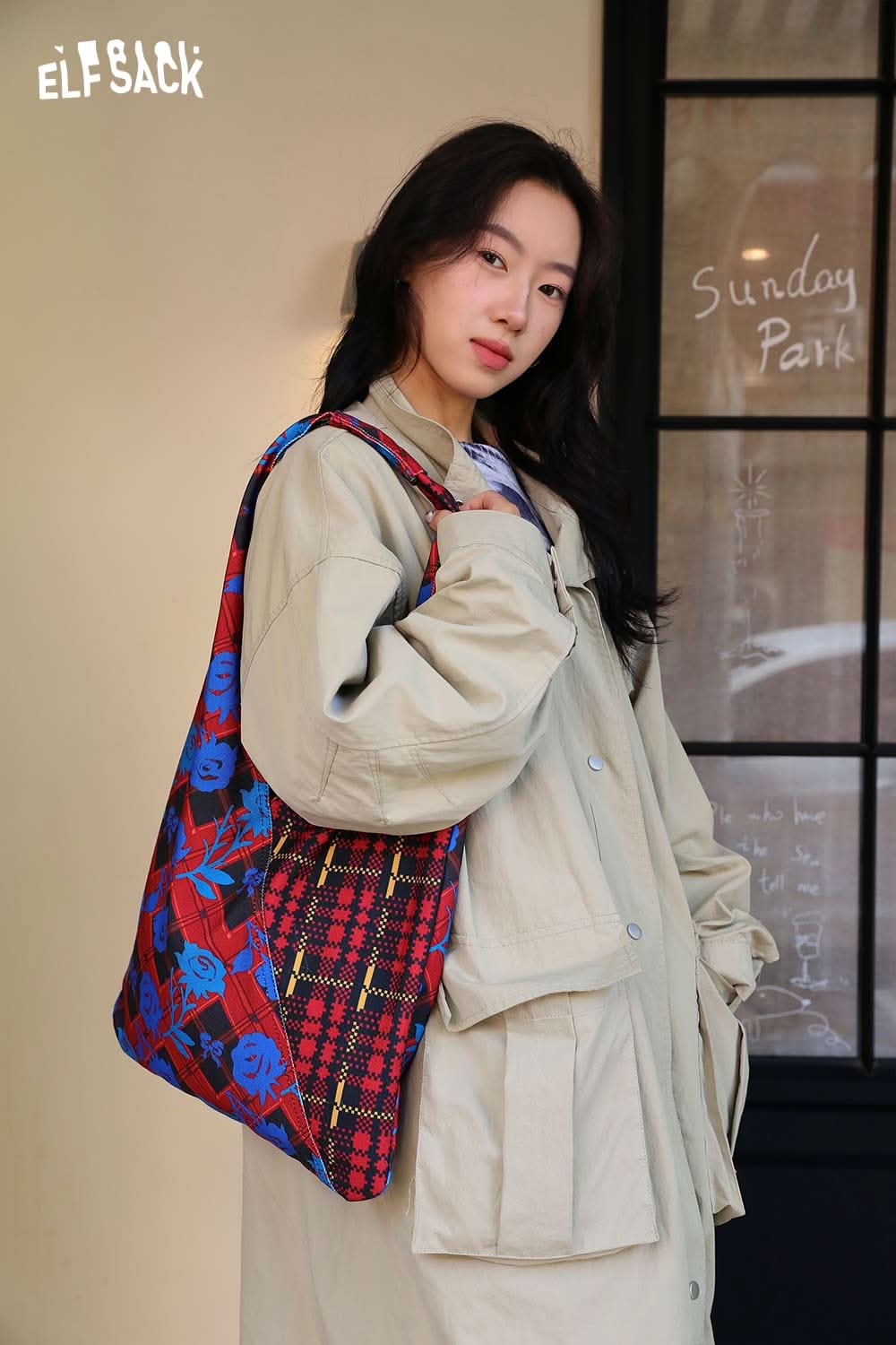 Stylish woman holding a vintage stripe tote bag featuring floral and plaid patterns for a trendy look