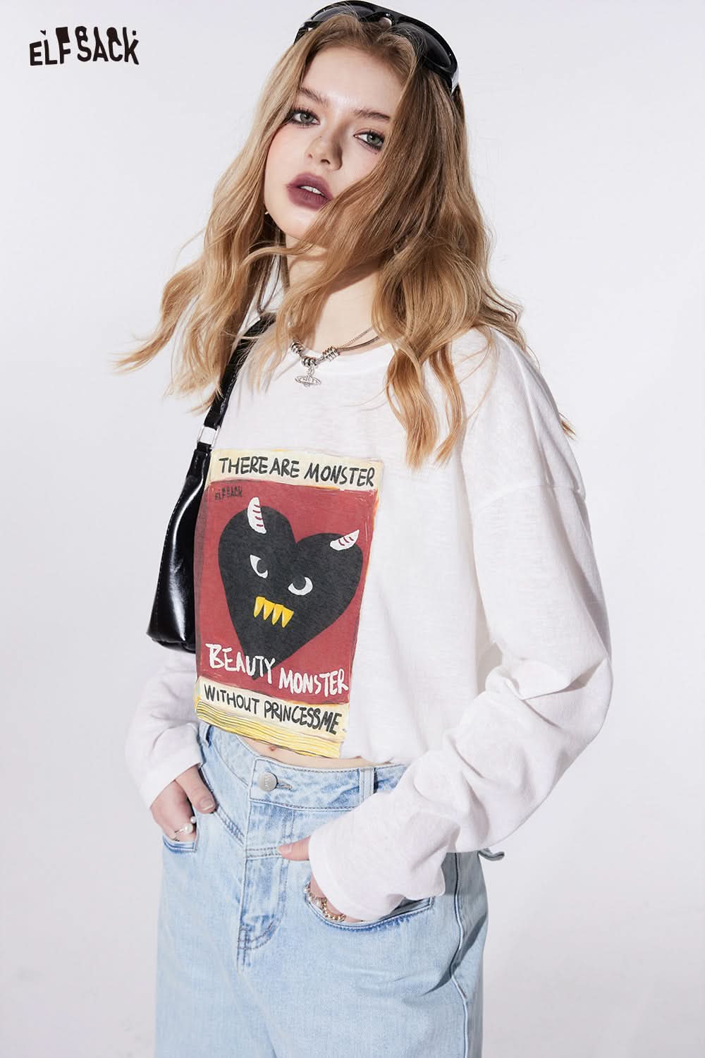 ELFSACK white graphic print T-shirt featuring monster design worn with light blue jeans