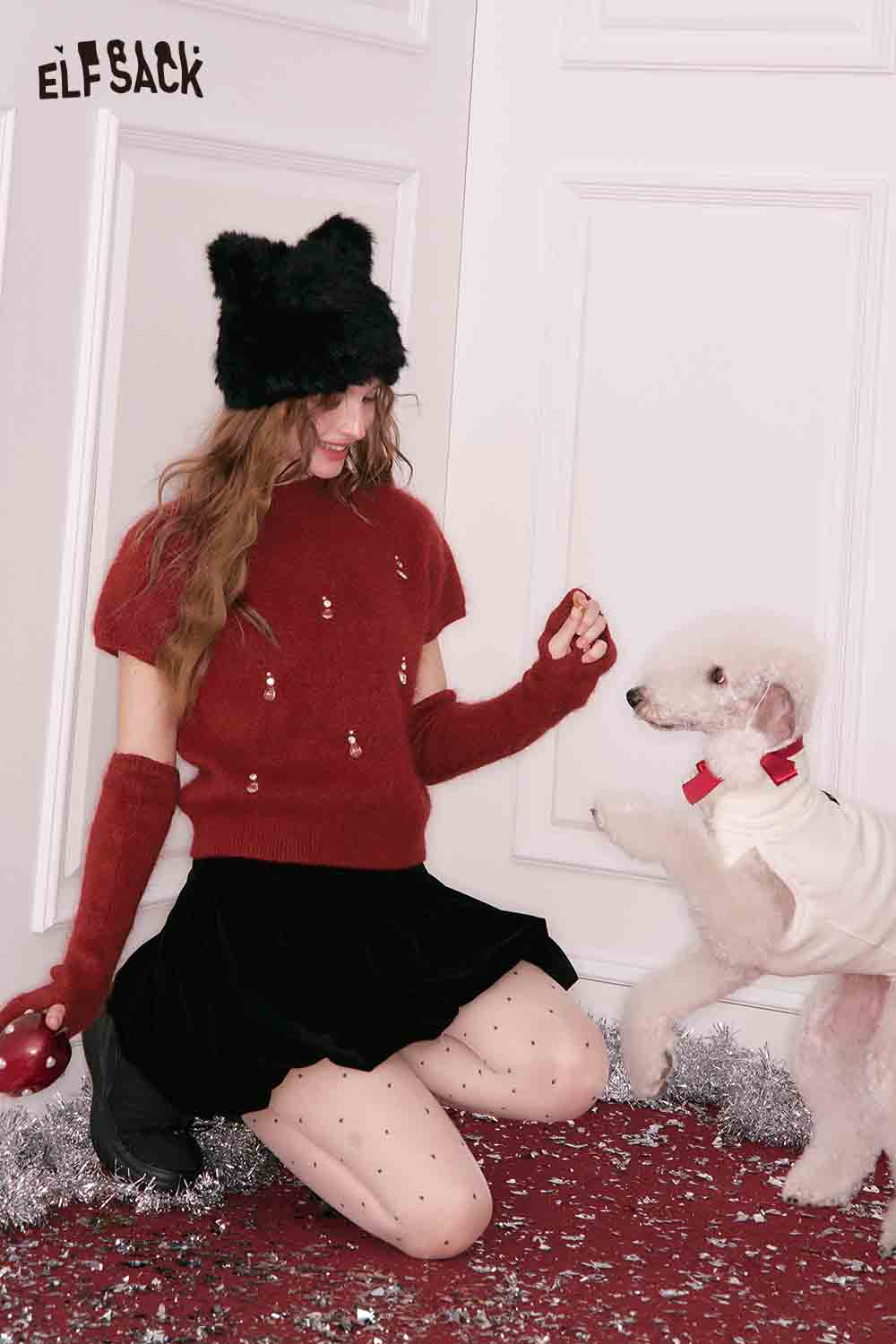 Festive ELFSACK Christmas rhinestone sweater for women paired with stylish accessories and a playful dog