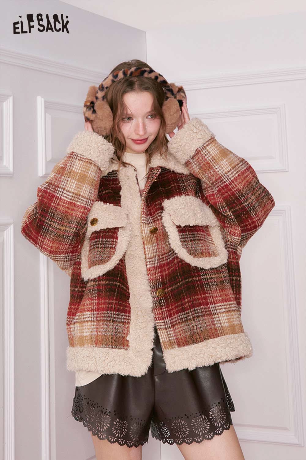 Trendy women's PU leather shorts paired with a cozy plaid jacket for a stylish autumn look