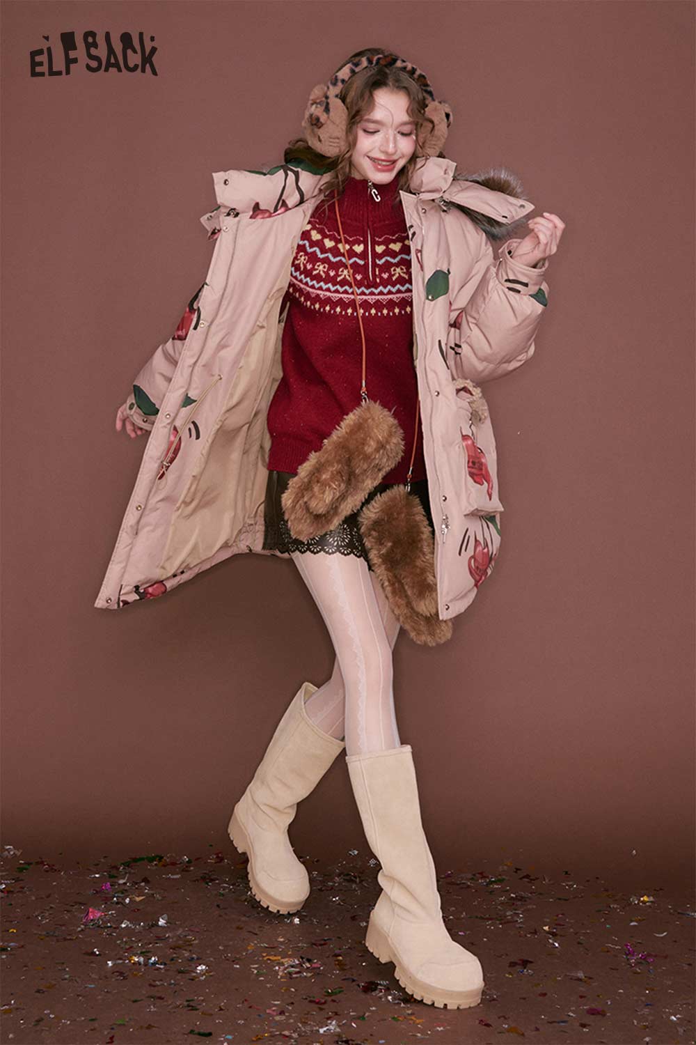 Trendy ELFSACK women's PU leather shorts styled with a cozy oversized coat for a chic winter look