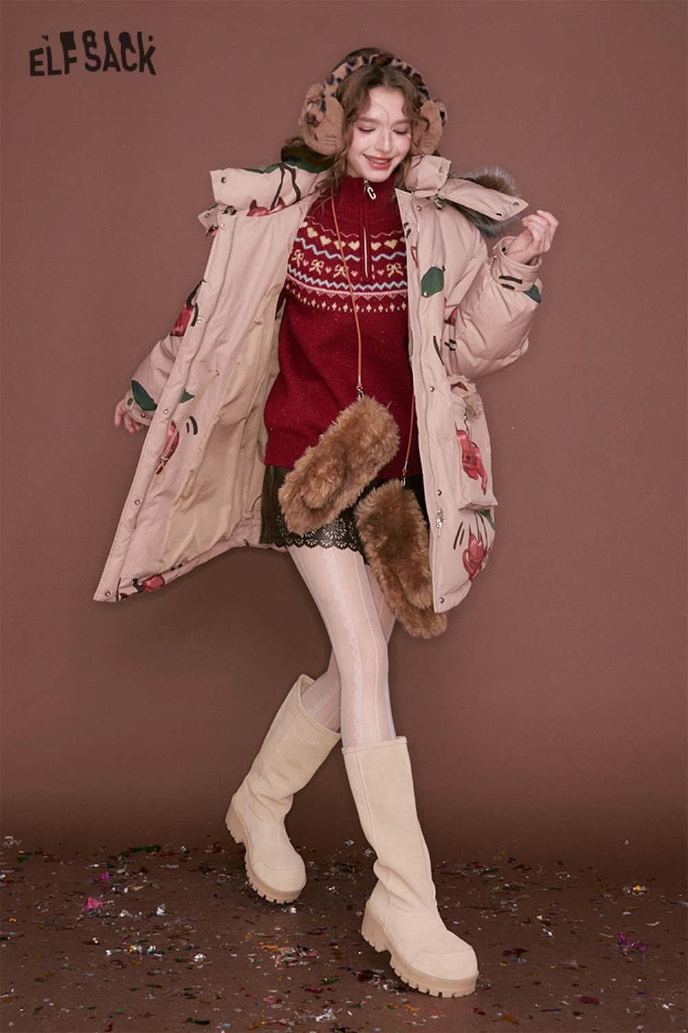 Trendy ELFSACK women's PU leather shorts styled with a cozy oversized coat for a chic winter look