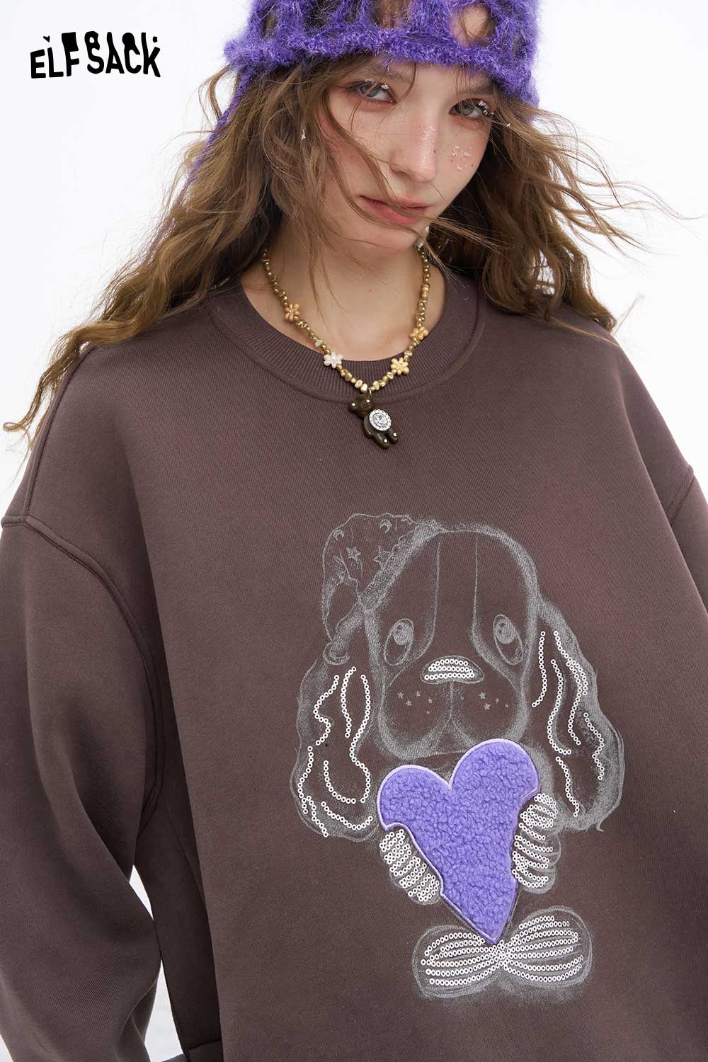 ELFSACK women's animal graphic sweatshirt featuring a cute dog holding a purple heart design