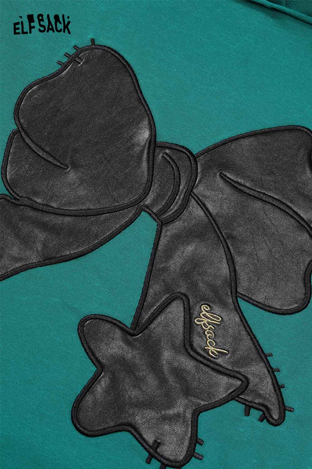 ELFSACK women's casual graphic hoodie featuring a stylish black bow design on a teal background