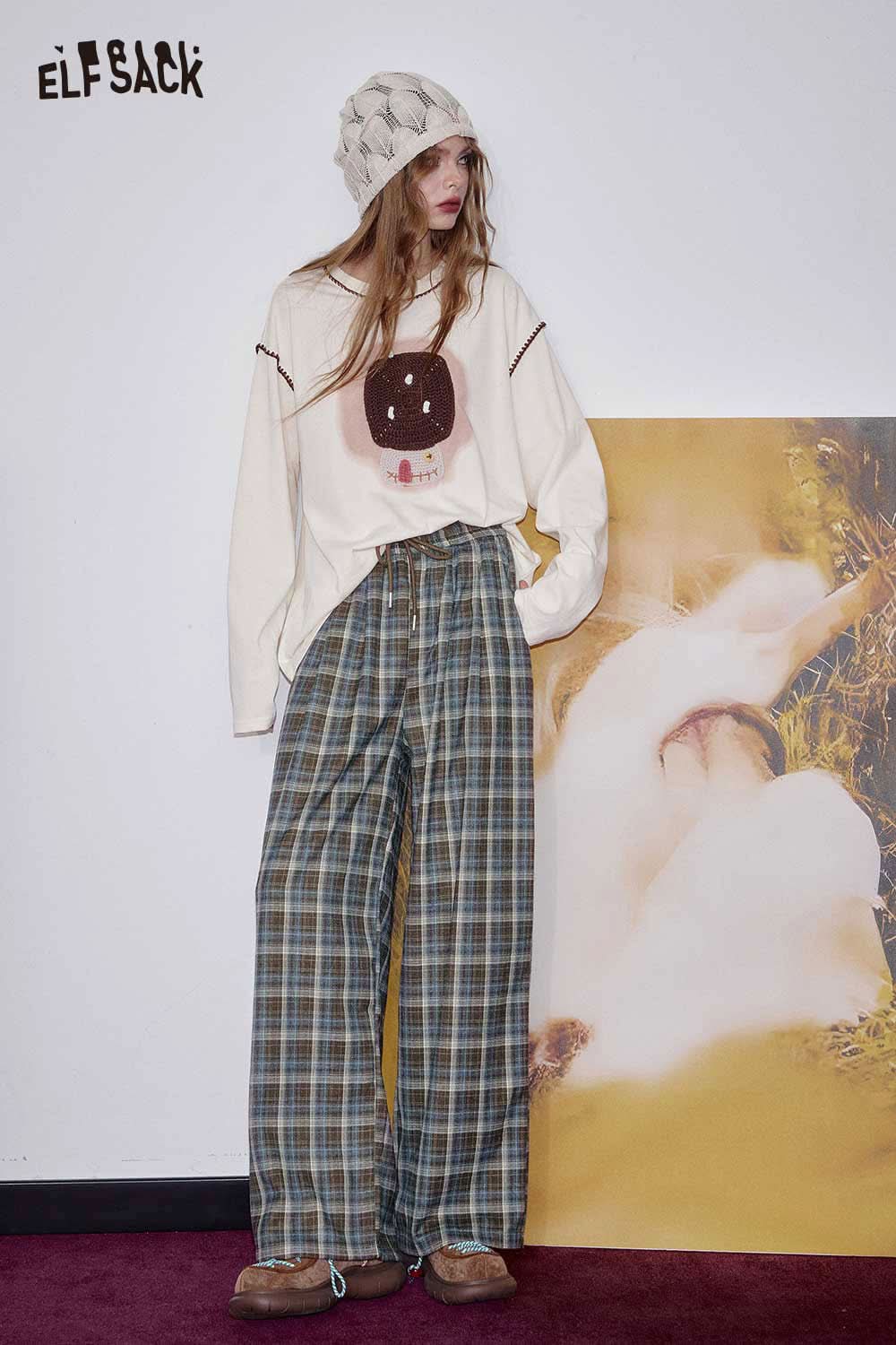 ELFSACK women's check pattern relaxed fit trousers styled with a graphic tee and beanie for a casual look