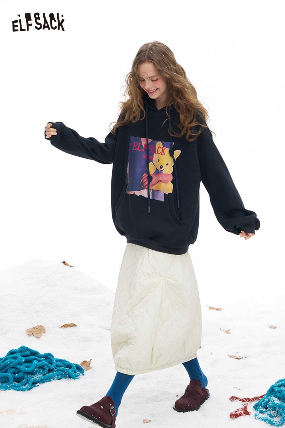 ELFSACK women's down half skirt styled with a cozy hoodie and colorful leggings for a trendy winter outfit.
