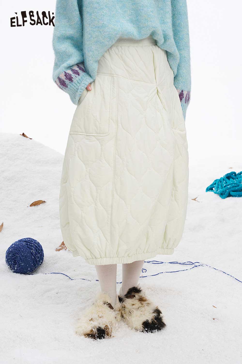 ELFSACK women's down half skirt in cream, featuring quilted design for winter warmth and style