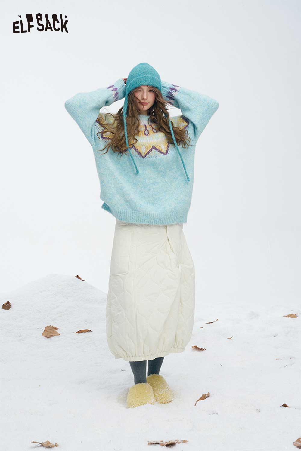 ELFSACK women's down half skirt in cream paired with a cozy sweater for a winter look