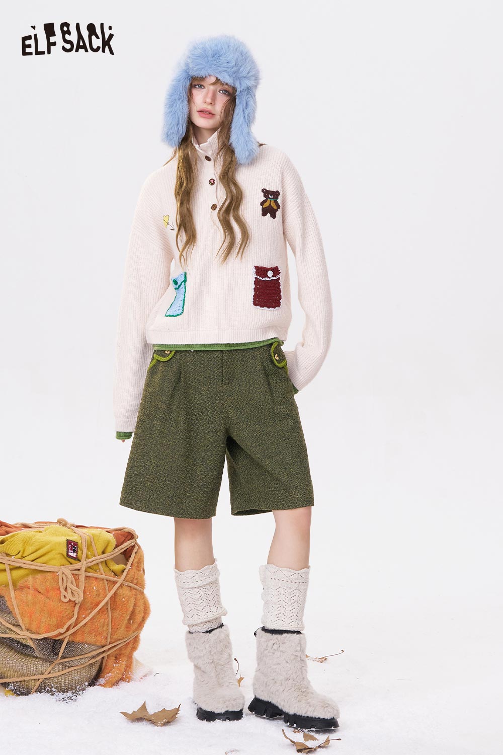 ELFSACK women's empire waist bermuda shorts in green paired with a cozy sweater and stylish accessories