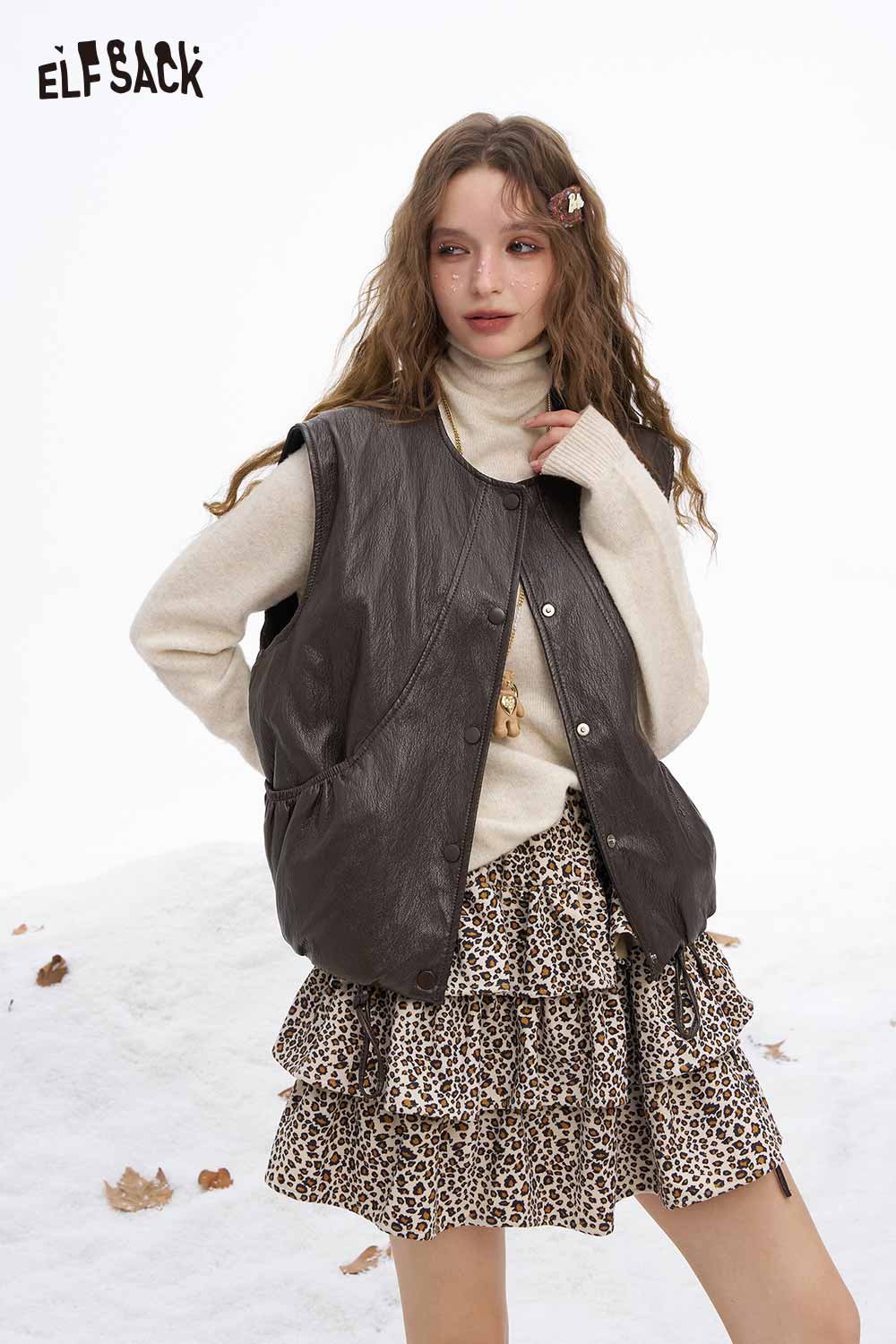 ELFSACK women's faux leather sleeveless jacket styled with a cream sweater and leopard print skirt