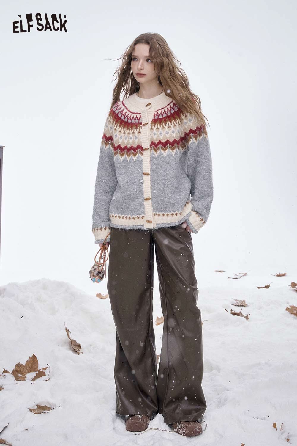 Model wearing ELFSACK women's faux leather straight leg pants styled with a cozy sweater in a winter setting