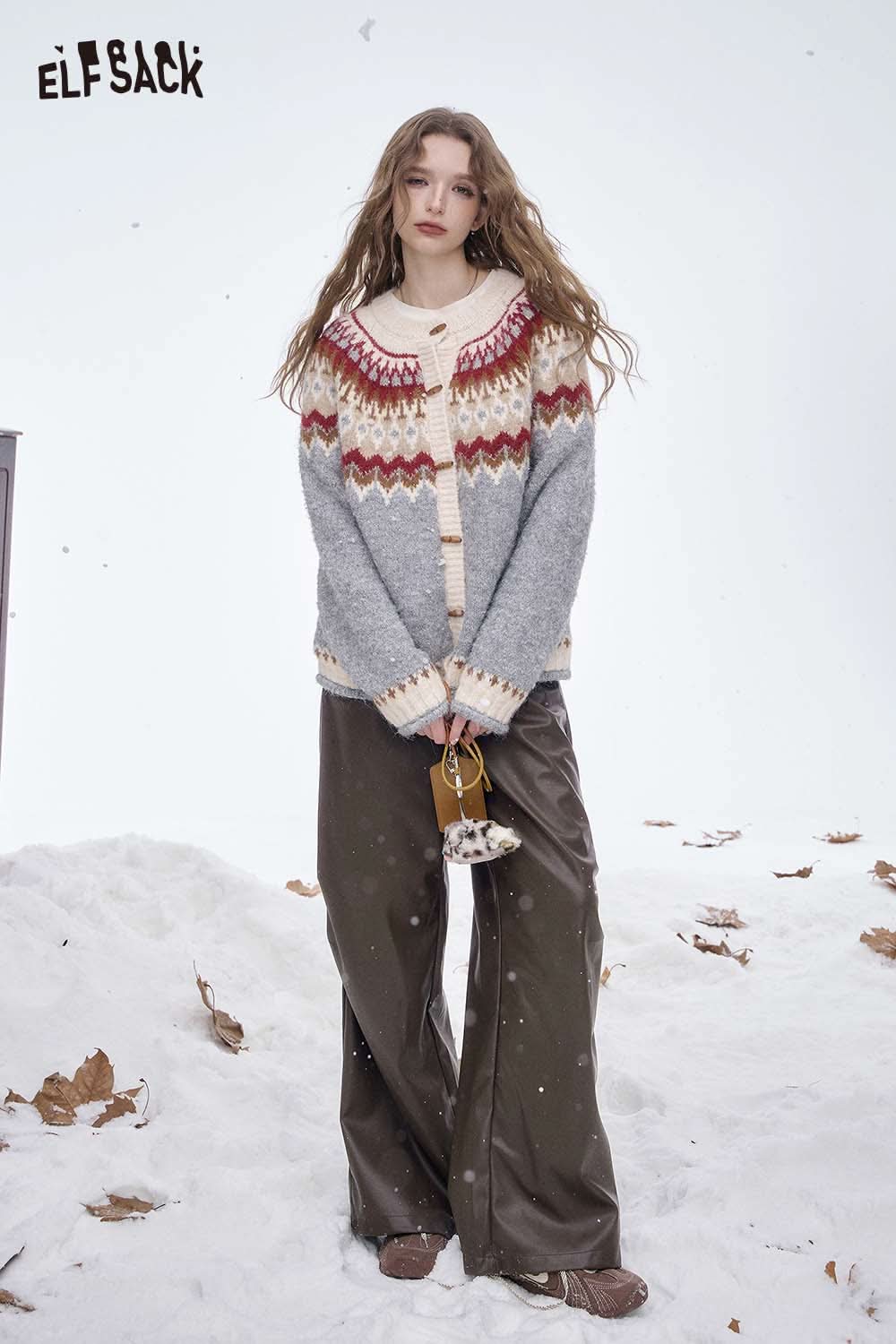 ELFSACK women's faux leather straight leg pants styled with a cozy knit cardigan in a snowy outdoor setting