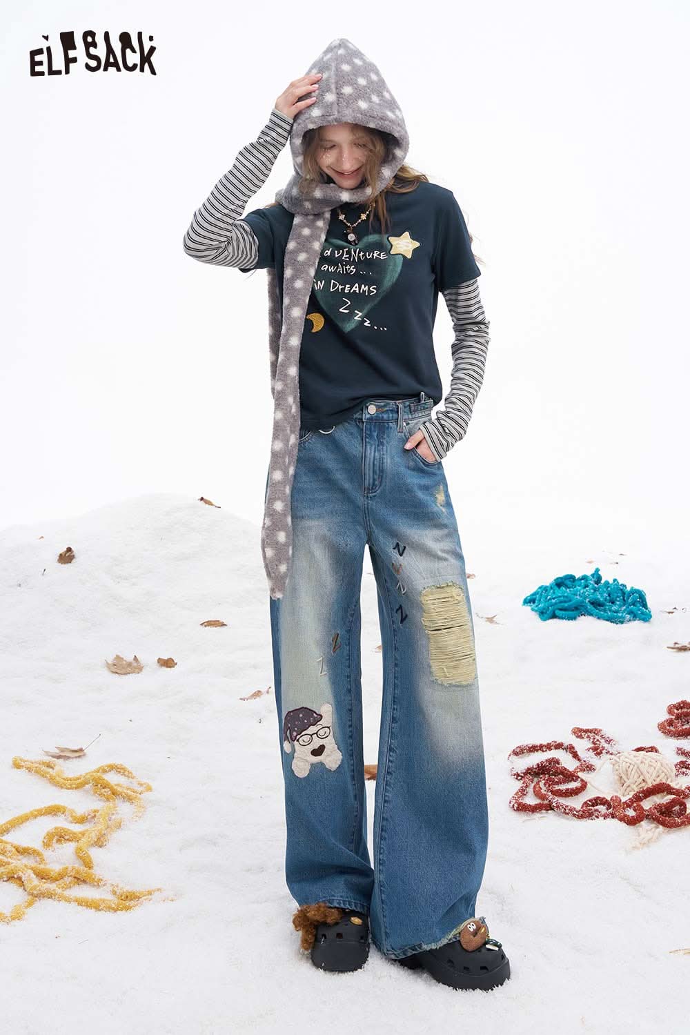 ELFSACK women's graphic embroidered long sleeve tshirt worn with a striped long-sleeve layer and casual wide-leg jeans