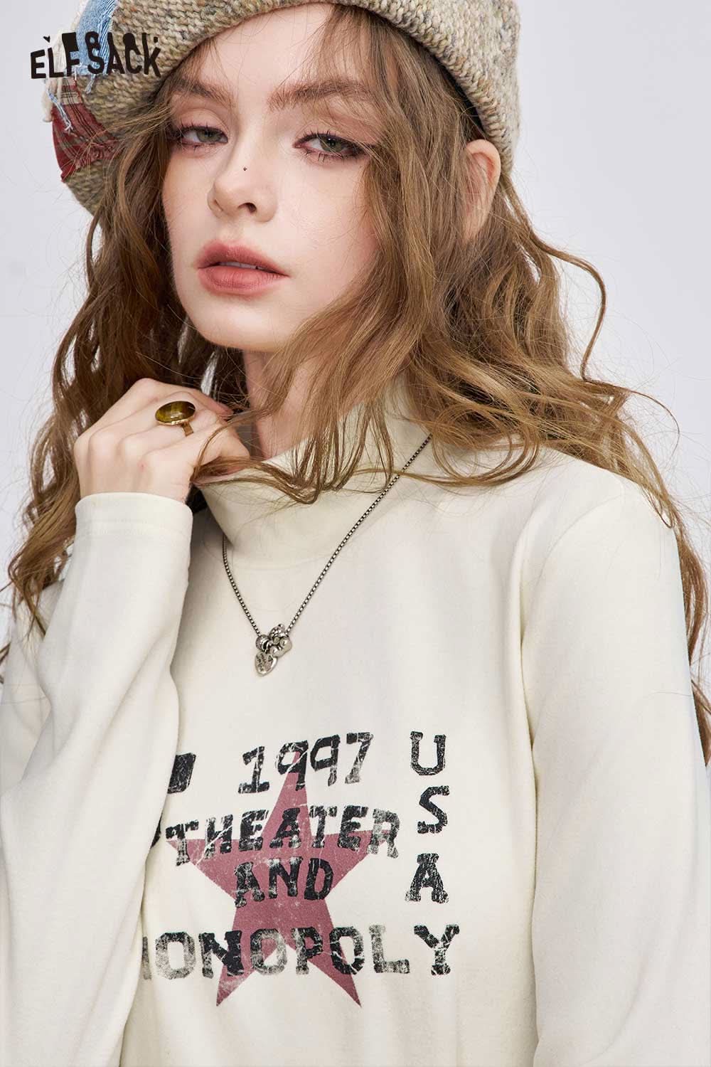 ELFSACK women's graphic long sleeve t-shirt in cream with theater and monopoly print details