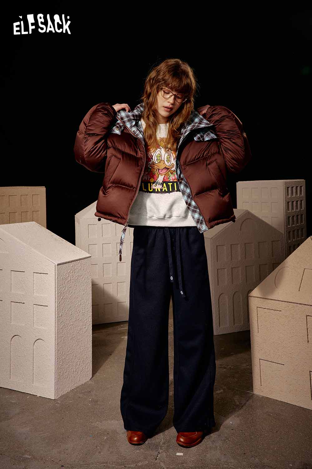 ELFSACK women's graphic sweatshirt paired with a brown puffer jacket and wide-leg pants