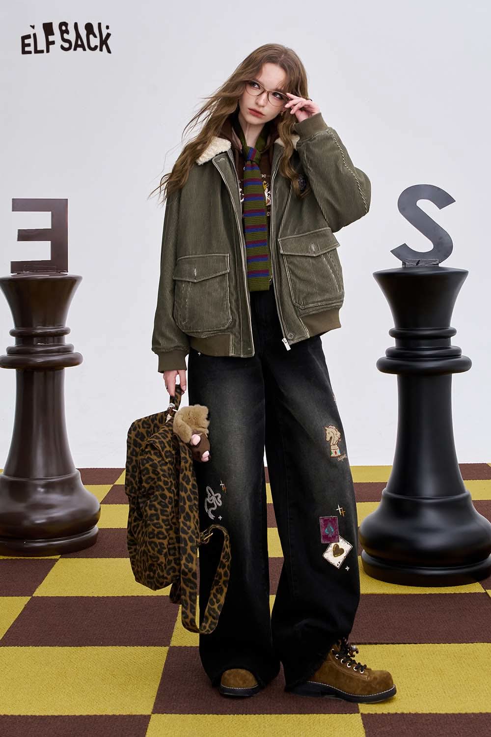 ELFSACK women's graphic wide leg pants styled with a trendy jacket and accessories in a playful setting