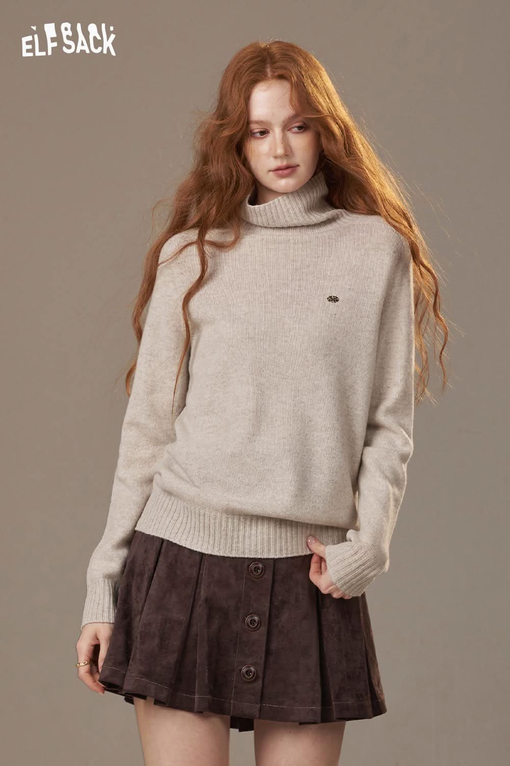 ELFSACK women's high neck knit sweater in light beige paired with a dark suede skirt