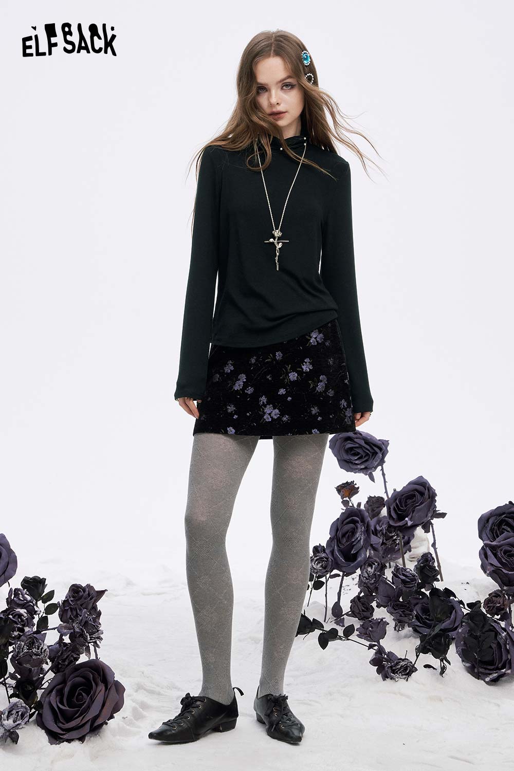 ELFSACK women's high neck pearl t-shirt in dark green styled with a floral skirt and gray tights