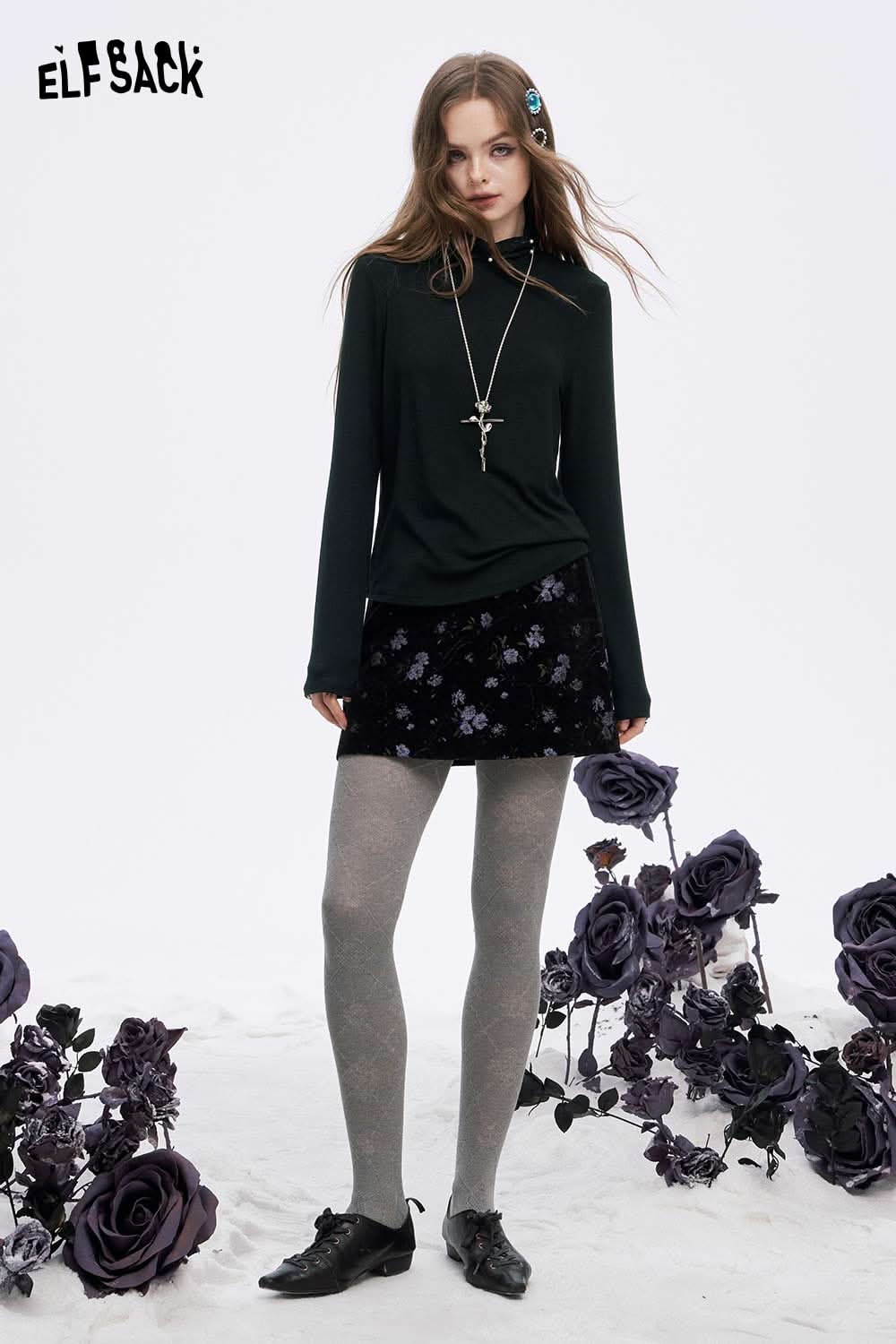 ELFSACK women's high neck pearl t-shirt in dark green styled with a floral skirt and gray tights