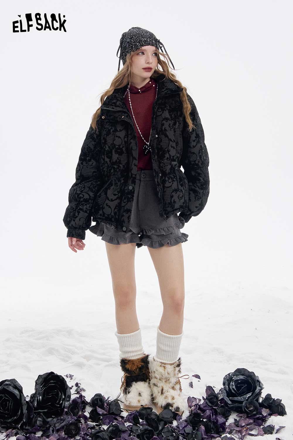 Trendy model wearing a stylish outfit showcasing a women's high neck pearl t-shirt under a black floral jacket