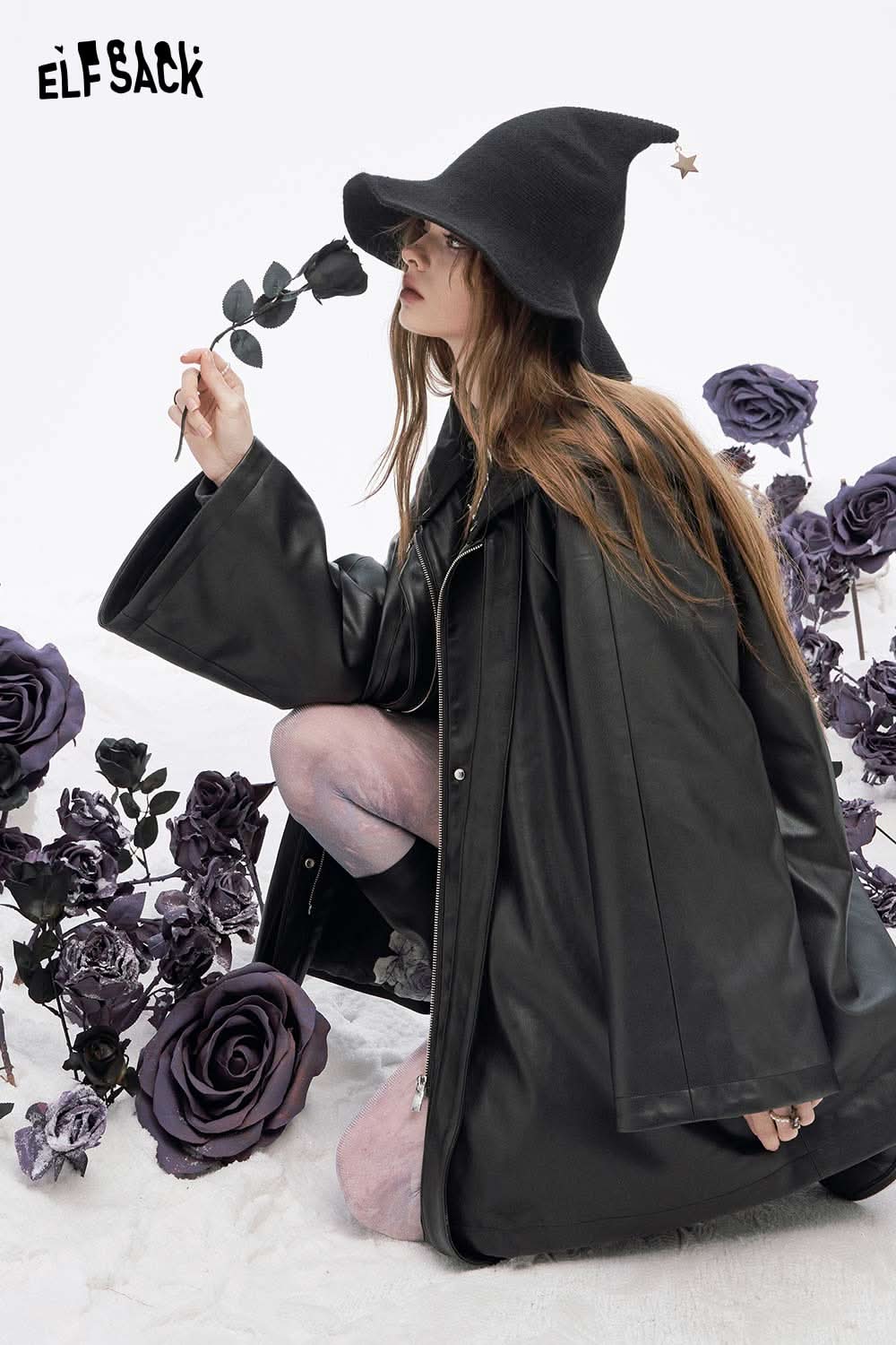 Model wearing ELFSACK women's leather hooded coat with oversized sleeves and black hat in stylish pose
