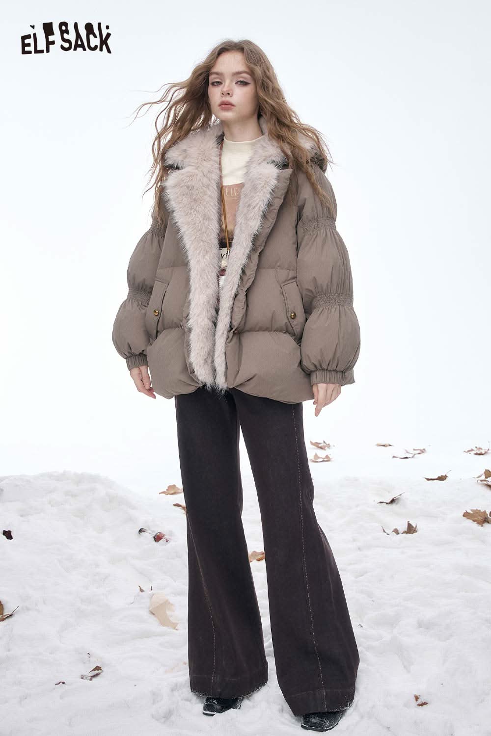 ELFSACK women's letter graphic long sleeve t-shirt styled under a warm puffer jacket in a winter setting