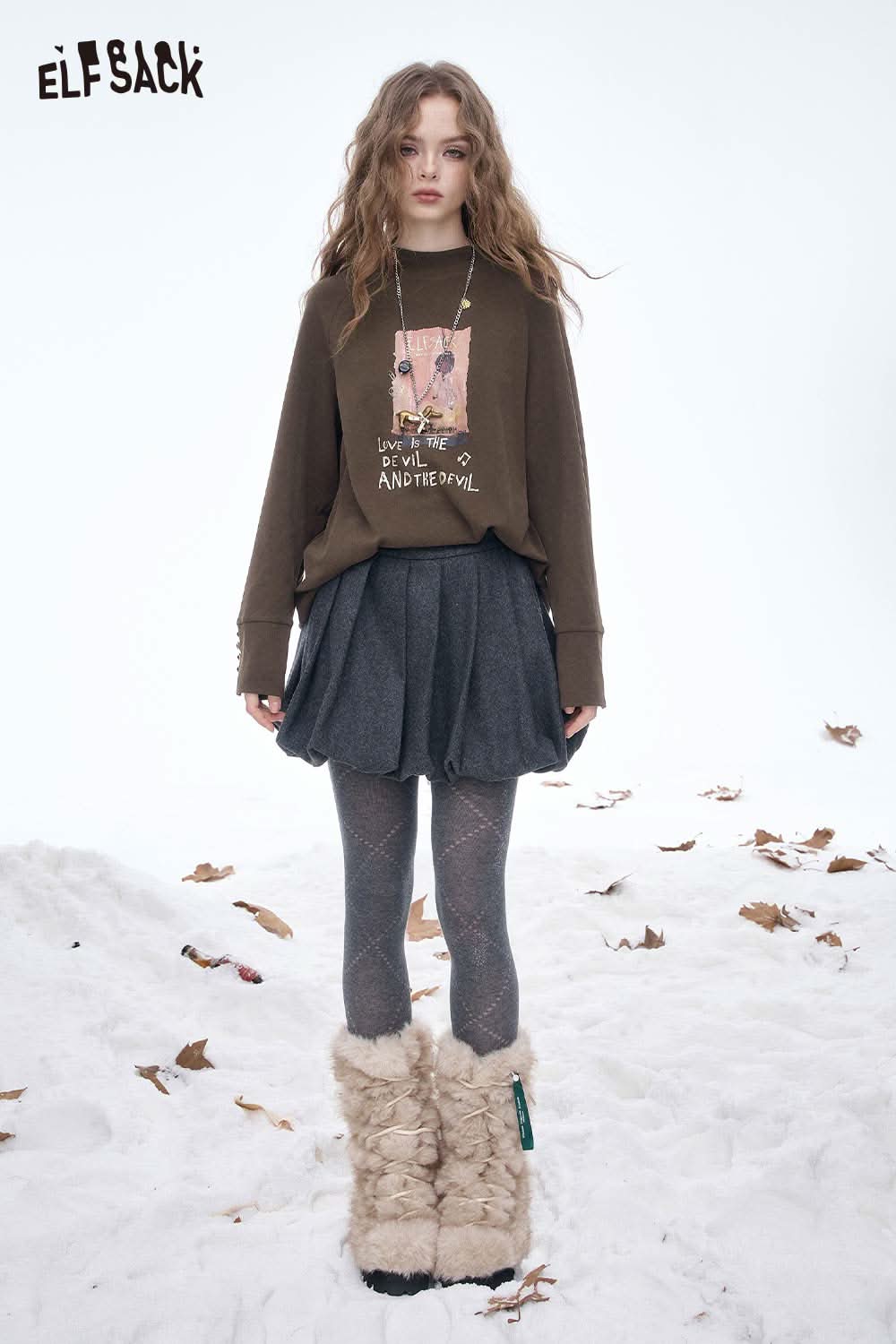 ELFSACK women's letter graphic long sleeve t-shirt paired with a skirt and stylish winter boots for a chic look