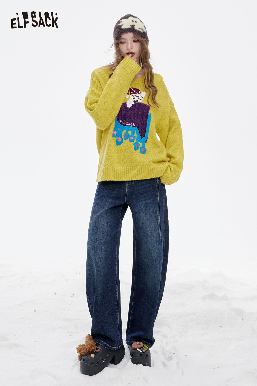ELFSACK women's loose fit floor length jeans paired with a cozy yellow sweater in a snow setting
