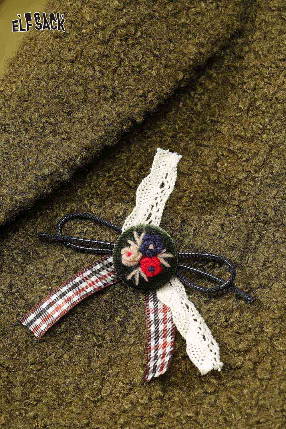 Close-up of ELFSACK women's minimalist blazer with decorative floral brooch detail