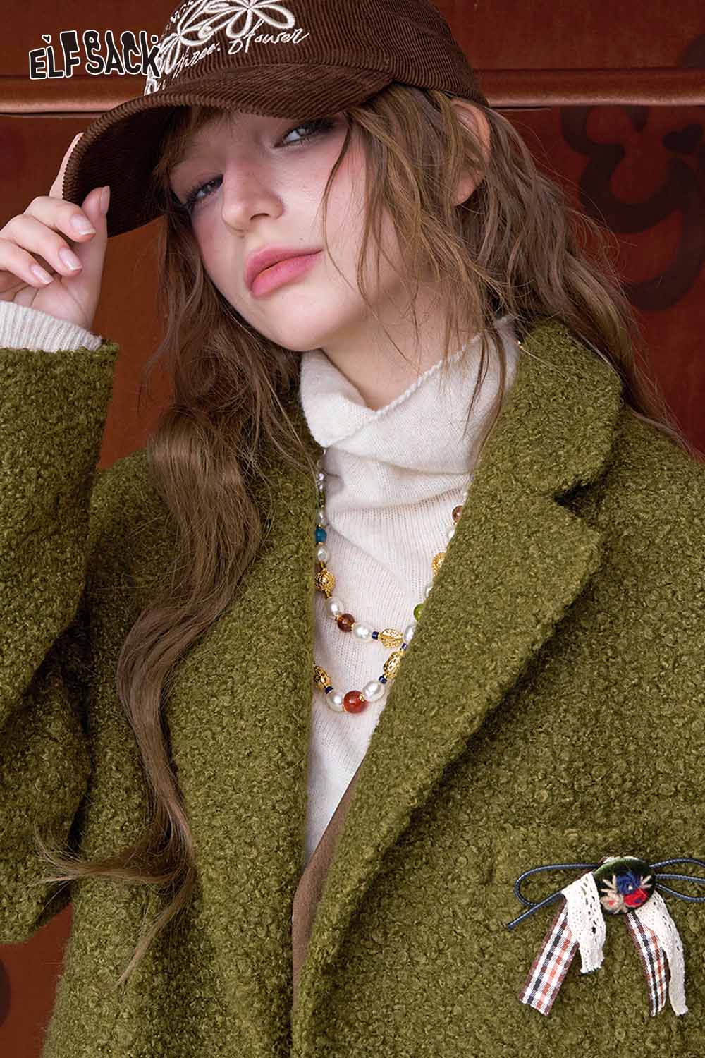 ELFSACK women's minimalist blazer in olive green with a stylish brooch and cozy turtleneck top